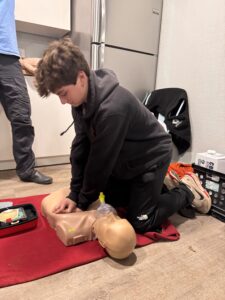 Scout performing CPR on a manakin.