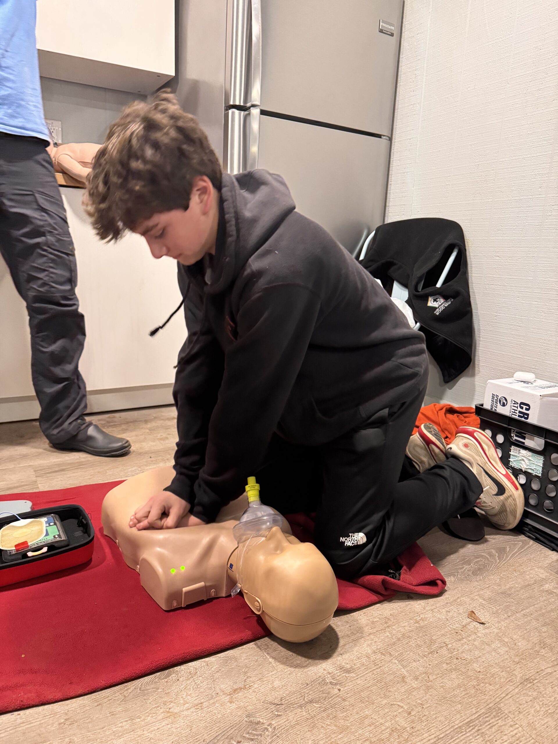 Scout performing CPR on a manakin.